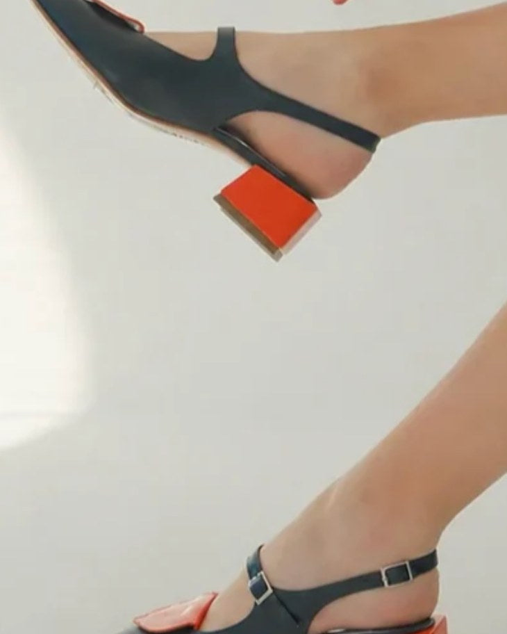 Detail of HUHUA slingbacks worn, red block heel